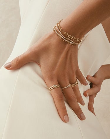 woman wearing lab grown diamond and solid gold bracelets